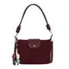 Bolso de hombro vintage de gamuza modelo nuevo 2026, bolso cruzado versátil de nicho para el día a día con correa de hombro de cuerda trenzada, bolso de axila con sensación de alta gama