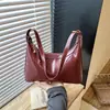 Bolso de axila texturizado transfronterizo para mujer, nuevo modelo 2026, bolso simple de media luna, bolso versátil para hombro y cruzado