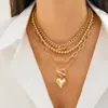 Collar de corazón multicapa europeo y americano con cuentas doradas y cadena gruesa, colgante en forma de corazón, cadena para la clavícula vintage para mujer al por mayor