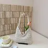 Versión coreana 2026 nueva bolsa tejida simple versátil hecha a mano, bolsa de dumplings para vacaciones, bolso de hombro de nicho, bolso de mujer de moda