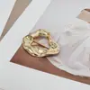 Hebilla decorativa metálica de forma irregular transfronteriza europea y americana con un toque de lujo ligero de alta gama para trajes de baño, hebilla anudada para ajuste de cintura