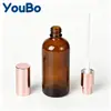 Botella de spray de vidrio ámbar de 10-100 ml en stock transfronteriza con boquilla de oro rosa, botella de perfume, botella de aceite esencial, botella de tónico