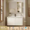 Tocador de baño engrosado y ahorrador de espacio con diseño en color crema, que cuenta con un lavabo redondeado, lavabo cerámico integrado y un lavabo de una sola pieza.