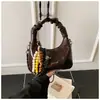 Bolsa de Mão Pequena Exquisita e Moderna Nova Coleção Primavera/Verão 2026 Versátil Bolsa Transversal com Corrente Mini Bolsa Feminina Estilo Dumpling