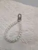 Llavero directo de fábrica hebilla de puerta colgante para teléfono móvil diy perla de imitación bolsa pequeña corta cartera muñeca cadena de mano venta al por mayor