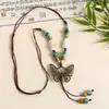 Collar con colgante de campana de mariposa de cerámica de estilo étnico retro para mujer, diseño nuevo y moderno, cadena larga para suéter, accesorios