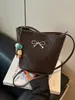 Bolso de hombro con lazo estilo coreano 2026 nuevo de moda para el día a día color liso bolso de axila elegante bolso cruzado tipo cubo