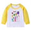 2026 Nova Camiseta Infantil Transfronteiriça Primavera e Outono Gola Redonda Desenho Animado Manga Longa Camisa Básica para Meninos e Meninas Camiseta de Algodão para Bebê