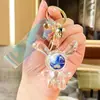 Colgante de llavero de conejo de orejas largas iridiscente de cristal transparente acrílico, decoración para coche y bolso, regalo exquisito de alta gama