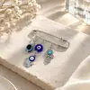 Broche de borla de ojo de diablo con incrustaciones de diamantes, estilo creativo europeo y americano, con sentido avanzado, ojos azules, suéter de cintura ajustada, broche de viento frío