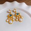 Pendientes de perlas artificiales con ojos vintage y aguja de plata para mujer, diseño exagerado, elegantes, de lujo ligero y de alta gama.