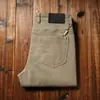 Estación europea otoño e invierno grueso cliente suministrado tejido sarga gruesa algodón cepillado para hombre rectos ajustados mezclilla casual pantalones