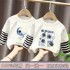 Camiseta de manga larga de algodón puro para niño, nuevo modelo primavera y otoño 2026, camiseta básica con estampado de dibujos animados para niño, top falso de dos piezas, moderno