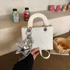 Bolsa Quadrada Pequena de Nicho Estilo Coreano Transfronteiriça para Mulheres 2026 Novo Modelo Bolsa de Mão Versátil de Alta Qualidade Bolsa de Ombro Transversal para o Dia a Dia