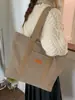 Bolsa Tote Comutadora de Lona Transfronteiriça para Mulheres 2025 Inverno Nova Tendência Grande Capacidade Estilosa Simples de Ombro ou Axila