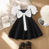 26 Vestido de verão com mangas bufantes e laço para meninas de comércio exterior, vestido de princesa estiloso e moderno, direto da fábrica