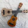 Ukelele para niños guitarra pequeña puede tocar grande, mediano y pequeño simulación niños y niñas Instrumentos musicales y juguetes para bebés al por mayor
