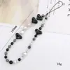 Nueva cadena de cuentas para teléfono móvil blanco y negro amor cordón para teléfono móvil colgante para teléfono móvil cuentas rayadas amor anti-pérdida tendencia portátil