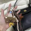 Lindo oso de peluche bolso colgante montañismo cuerda mano cuerda muñeca de dibujos animados colgante coche llavero moda