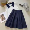 Saia midi cáqui estilo college 2026 novo design de primavera saia midi de bolso estilo japonês que rejuvenesce saia evasê versão coreana