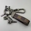 Chaveiro de Dinossauro Fofo Desenho Animado Pingente de Metal Estilo Casal para Carro Masculino Chaveiro de Corda de Couro de Alta Qualidade para Pendurar na Cintura
