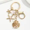 Temu AliExpress Llavero Colgante Estrella de Mar Perla Vieira Cruz Europea Americana Aleación Estrella de Mar Concha Accesorios para Bolsos