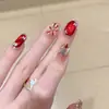 Bestseller de Xiaohongshu Uñas Portátiles Hechas a Mano Rojo Vino Ojo de Gato Brillo Dorado Fuegos Artificiales con Pedrería Puntas de Uñas Estilo Tendencia China Uñas Postizas