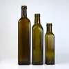 Fabricantes de botellas de vidrio suministran botella transparente para aceite de oliva empaque sellado botella marrón para aceite de sésamo botella verde oscuro para vinagre botella para aceite de camelia
