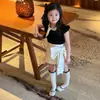 Conjunto para Niña 2026 Verano Nuevo Infantil Súper Lindo Dulce Estilo Hepburn Camiseta de Manga Abullonada Falda Corta con Lazo