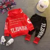 Otoño coreano nuevo conjunto de dos piezas para hombre y mujer, versión holgada de sudadera con capucha y pantalones con letras, conjunto de una generación de pelo