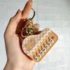 Nuevo Llavero de Mini Piano Transfronterizo Dibujo Animado Lindo Tocando el Piano Sanrio Juguete Musical Colgante Pequeño