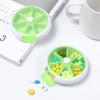 Suministro de fábrica mini pastillero portátil de 7 compartimentos pastillero de frutas redondo giratorio transparente sub-embalaje de tabletas pastillero en stock