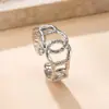 Joyería Transfronteriza de Acero de Titanio Europea y Americana Anillo Cruzado Hueco por Presión de Aceite Anillo sin Color de Acero de Titanio con Sentido de Diseño de Nicho para Mujer