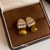 Brincos de renda vazada estilo retrô francês com zircônias cúbicas e pedras de olho de tigre, em uma paleta de cores Melard, oferecendo um visual luxuoso e sofisticado, e um acessório da moda