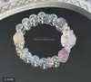 Pulsera bicolor de cristal azul natural y cristal rosa con diseño de oso y rosa, una pulsera blanca de lujo ligero y estilo antiguo fresco.