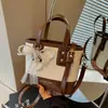 Bolso pequeño súper popular para el trabajo, bolso de hombro tejido para mujer nuevo de verano 2026, bolso cruzado tipo cubo para ir al trabajo