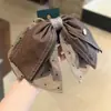 Pinza para el pelo de cuero marrón Maillard con lunares y lazo, estilo delicado y femenino, nueva pinza para el pelo de media coleta, muestra el volumen del cabello, versátil