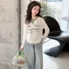 Camiseta de manga larga de dos piezas de imitación para niñas, nuevo estilo primavera/otoño 2026, top base de estilo coreano moderno para niñas mayores y estudiantes de secundaria