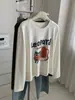 Camiseta Larga de Algodón Cepillado con Estampado de Dibujos Animados Lindos Estilo Coreano para Mujer 2026 Otoño Nueva Holgada Versátil Estilo Ins Superior
