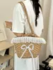 Bolso de paja de diseño único para mujer, gran capacidad, nuevo modelo 2026, lindo bolso de hombro, bolso tipo cubo de playa estilo vacación en la playa