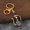 Llavero de frasco de lámpara mágica estilo étnico retro con diamantes, colgante metálico de tetera con goteo de aceite, decoración de bolsa de recuerdo de viaje