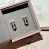 Pendientes de botón de plata s925 con aguja, nudo de lazo cepillado, pendientes de cristal blanco natural, joyería para orejas de lujo ligero, sentido de alta gama, sentido de diseño, nicho