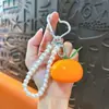 Pingente de chaveiro de corrente de pérolas de frutas simuladas, doce e versátil, design fresco e simples, moderno e único