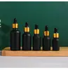 Frasco de Óleo Essencial Preto Tampa de Madeira Fosca Frasco Conta-gotas para Óleo Essencial Frasco de Vidro Cosmético Fabricante Atacado Frasco Vazio