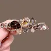 Pinza para el pelo de mariposa de cristal de alta gama para mujer, elegante y versátil, nuevo estilo para peinados semi-recogidos, pinza de resorte de lujo ligero