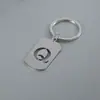 Venta Caliente de Productos Nuevos Transfronterizos 26 Letras Inglesas Huecas de Acero de Titanio Sin Decoloración Accesorios de Joyería Llavero 26 Letras