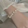 Elegante Pulseira de Opala 2025 Nova Feminina Primavera e Verão Trevo de Quatro Folhas Corda de Fio de Cristal Corda de Fio de Pérola Transferência