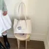 Bolsa Tote para Mujer de Gran Capacidad Simple Elegante para Viajar Estudiante Universitario 2025 Nueva Versátil de un Hombro Lona Bolsa de Verano
