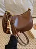 Bolso de axila retro de alta gama para mujer, nuevo y moderno bolso de hombro de nicho 2025 para el trabajo y los desplazamientos, bolso cruzado tipo dumpling