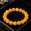 Transmisión en vivo popular pulsera de ojo de gato dorado cálido pulsera de cuentas redondas fluidas con textura de ámbar accesorios Wenwan en stock al por mayor